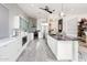 Bright kitchen featuring white cabinetry, granite countertops, and a stylish backsplash at 8100 E Camelback Rd # 41, Scottsdale, AZ 85251