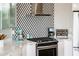 Modern kitchen details, including cooktop and backsplash at 8100 E Camelback Rd # 41, Scottsdale, AZ 85251