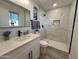 Updated bathroom with white vanity, marble shower, and modern fixtures at 8448 E Cambridge Ave, Scottsdale, AZ 85257