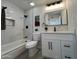 Updated bathroom with white vanity, marble tile, and modern fixtures at 8448 E Cambridge Ave, Scottsdale, AZ 85257