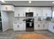 Modern kitchen with white cabinets, quartz countertops, and stainless steel appliances at 8448 E Cambridge Ave, Scottsdale, AZ 85257