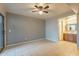 Bedroom with bathroom access, tile floors and ceiling fan at 850 S River Dr # 1092, Tempe, AZ 85281
