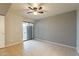 Bedroom with tile floors, ceiling fan and access to a patio at 850 S River Dr # 1092, Tempe, AZ 85281