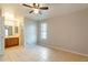 Bedroom with bathroom access, tile floors and ceiling fan at 850 S River Dr # 1092, Tempe, AZ 85281