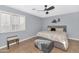 Cozy bedroom with ceiling fan and window shutters at 8729 W Tonopah Dr, Peoria, AZ 85382