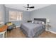 Bright bedroom with ceiling fan and window shutters at 8729 W Tonopah Dr, Peoria, AZ 85382
