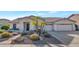 Single-story home with desert landscaping and two-car garage at 8729 W Tonopah Dr, Peoria, AZ 85382