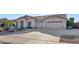 Single-story home with a two-car garage and well-manicured landscaping at 8729 W Tonopah Dr, Peoria, AZ 85382