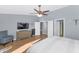 Main bedroom with dresser, TV, and access to bathroom at 8729 W Tonopah Dr, Peoria, AZ 85382