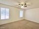 Bright bedroom with neutral carpeting and ceiling fan at 901 N Menze St, Casa Grande, AZ 85122