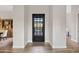 Elegant entryway with a black metal door and wood-look flooring at 9594 E Mountain Spring Rd, Scottsdale, AZ 85255