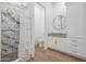 Modern bathroom with marble shower, granite vanity, and white cabinetry at 10428 S 294Th Ave, Palo Verde, AZ 85343