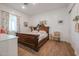 Bright bedroom with wood flooring and a large, ornate bed at 10428 S 294Th Ave, Palo Verde, AZ 85343