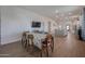 Bright dining room with wood table and chairs, kitchen view at 10428 S 294Th Ave, Palo Verde, AZ 85343