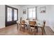 Bright dining room features a wood table with six chairs and an ornate entry door at 10428 S 294Th Ave, Palo Verde, AZ 85343