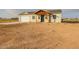 Single story home with a covered porch and sandy yard at 10428 S 294Th Ave, Palo Verde, AZ 85343