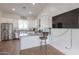 Modern kitchen with white cabinets, granite countertops, and stainless steel appliances at 10428 S 294Th Ave, Palo Verde, AZ 85343