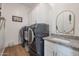 Convenient laundry room with washer, dryer, and granite countertop at 10428 S 294Th Ave, Palo Verde, AZ 85343