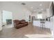 Open living room and kitchen area with hardwood floors and a crib in the background at 10428 S 294Th Ave, Palo Verde, AZ 85343