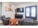 Cozy living room features leather seating, a large TV, and ornate double doors at 10428 S 294Th Ave, Palo Verde, AZ 85343