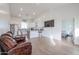 Open living room with hardwood floors, brown leather couches and views into the kitchen at 10428 S 294Th Ave, Palo Verde, AZ 85343