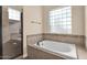 Bathroom with soaking tub, glass-enclosed shower, and tile flooring at 12692 W Toltec Cir, Casa Grande, AZ 85194