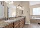 Double vanity bathroom with granite countertop and large soaking tub at 12692 W Toltec Cir, Casa Grande, AZ 85194