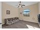 Bright bedroom with ceiling fan, carpet, and large window at 12692 W Toltec Cir, Casa Grande, AZ 85194