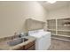 Laundry room with washer, dryer, shelving, and granite countertop at 12692 W Toltec Cir, Casa Grande, AZ 85194