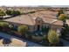 Stunning aerial view of a single-story home with a tile roof, desert landscaping, and mountain views at 1397 E Verde Blvd, Queen Creek, AZ 85140