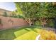 Landscaped backyard with artificial turf and trees at 1397 E Verde Blvd, Queen Creek, AZ 85140