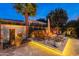 Serene backyard patio featuring a modern water feature, comfortable seating, and a cozy fire pit at 1397 E Verde Blvd, Queen Creek, AZ 85140