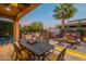 Outdoor dining area with a grill station and comfortable seating around a water feature at 1397 E Verde Blvd, Queen Creek, AZ 85140