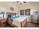 Guest bedroom with wooden furniture, soft bedding, and decorative accents at 1397 E Verde Blvd, Queen Creek, AZ 85140