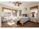 Bright bedroom with plush carpet, ceiling fan, multiple windows, and stylish furnishings at 1397 E Verde Blvd, Queen Creek, AZ 85140