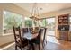 Charming dining area with rustic wooden table and access to the patio at 1397 E Verde Blvd, Queen Creek, AZ 85140