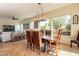 Open dining area with a large wooden table and leather chairs at 1397 E Verde Blvd, Queen Creek, AZ 85140