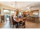 Bright dining room with wooden table, leather chairs, and access to backyard at 1397 E Verde Blvd, Queen Creek, AZ 85140