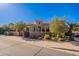 Tan two-story house with landscaped yard and gated entrance at 1397 E Verde Blvd, Queen Creek, AZ 85140