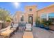 Gorgeous front patio featuring comfortable seating, lush landscaping, and a sunny ambiance at 1397 E Verde Blvd, Queen Creek, AZ 85140