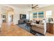 Relaxing living room with sectional sofa, large TV, and ceiling fan at 1397 E Verde Blvd, Queen Creek, AZ 85140