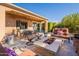 Covered patio with fire pit, seating area and outdoor kitchen at 1397 E Verde Blvd, Queen Creek, AZ 85140