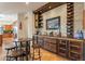 Rustic wet bar with wine storage and seating area at 1397 E Verde Blvd, Queen Creek, AZ 85140