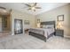 Spacious bedroom with king bed, ceiling fan, and large mirror at 14113 W Windsor Ave, Goodyear, AZ 85395