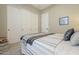 Bedroom with striped bedding and plenty of closet space at 14113 W Windsor Ave, Goodyear, AZ 85395