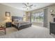 Main bedroom with king-size bed, ceiling fan, and large window at 14113 W Windsor Ave, Goodyear, AZ 85395