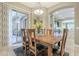 Bright dining room with wooden table and access to backyard patio at 14113 W Windsor Ave, Goodyear, AZ 85395