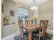 Elegant dining room with wooden table and views into kitchen at 14113 W Windsor Ave, Goodyear, AZ 85395