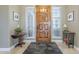 Bright entryway with wood floors and a beautiful wood door at 14113 W Windsor Ave, Goodyear, AZ 85395