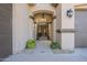 Elegant entry with wrought iron gate and mature shrubs at 14113 W Windsor Ave, Goodyear, AZ 85395